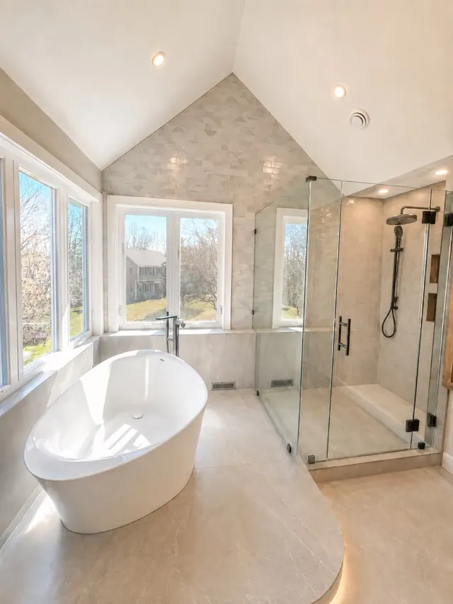 Master bathroom after the remodel with a freestanding tub and frameless glass shower