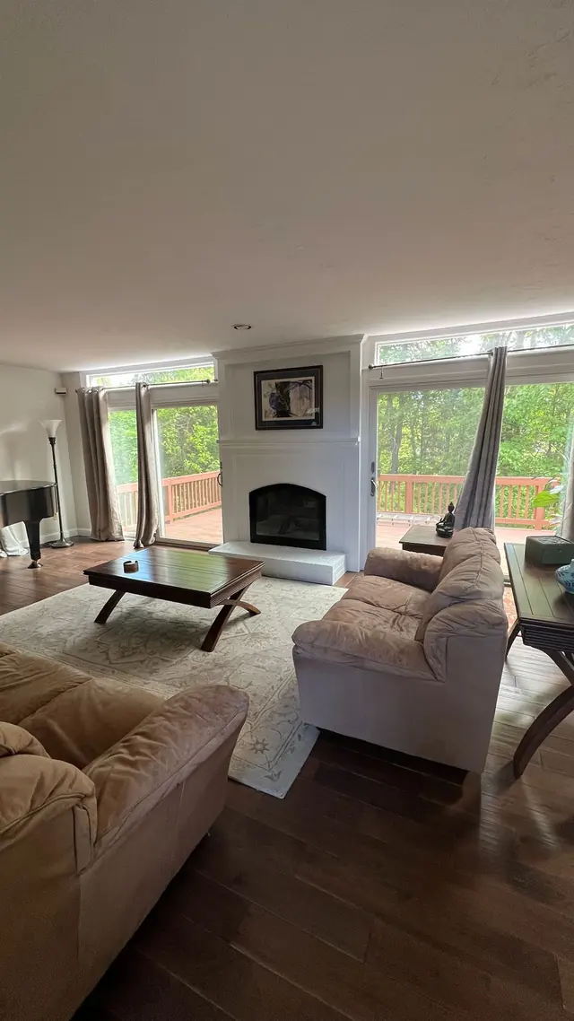 Living room with new hardwood floors and the refreshed fireplace in Marlborough, MA