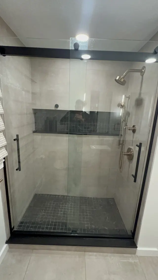 Tiled shower with glass doors after the main bathroom remodel in Marlborough, MA