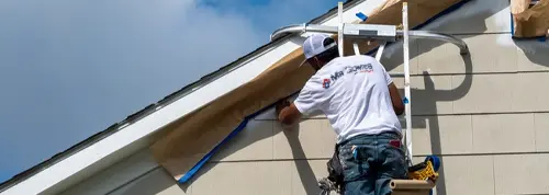 Mr. Gomes Remodeling painter working on an exterior house painting job in Massachusetts